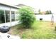Backyard featuring lush greenery, with a view of the home and a white privacy fence at 4633 Mapletree Loop, Wesley Chapel, FL 33544