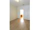 An empty bedroom featuring wood-look tile flooring, a door, and a ceiling light at 4633 Mapletree Loop, Wesley Chapel, FL 33544