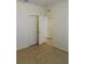 Bedroom with bi-fold closet and wood-look tile flooring and a door to a hallway at 4633 Mapletree Loop, Wesley Chapel, FL 33544