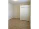 Bedroom featuring wood-look tile flooring and a bi-fold door closet at 4633 Mapletree Loop, Wesley Chapel, FL 33544