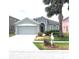 Charming single-story home with well-manicured lawn, palm tree, and attached two-car garage at 4633 Mapletree Loop, Wesley Chapel, FL 33544