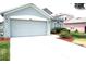 Picture of the home's exterior, featuring an attached garage and well-maintained front yard at 4633 Mapletree Loop, Wesley Chapel, FL 33544