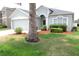 Well-maintained lawn with a mature palm tree in front of this appealing single story residence at 4633 Mapletree Loop, Wesley Chapel, FL 33544