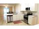 An open-concept kitchen featuring stainless steel appliances and white cabinetry at 4633 Mapletree Loop, Wesley Chapel, FL 33544