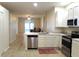 Modern kitchen with stainless steel appliances, lots of counter space, and white cabinetry at 4633 Mapletree Loop, Wesley Chapel, FL 33544