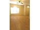 Bright living area features hard surface flooring, large window, and fan for added comfort at 4633 Mapletree Loop, Wesley Chapel, FL 33544