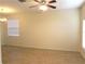 Spacious living room with fan, light colored walls, neutral trim, and attractive hard surface floors at 4633 Mapletree Loop, Wesley Chapel, FL 33544