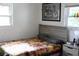 Cozy bedroom featuring bright walls, a colorful bedspread, a gray headboard and a motorcycle image on the wall at 4928 Lake Ridge Ln, Holiday, FL 34690
