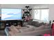 Comfortable living room with a plush gray couch, large window and modern entertainment setup, perfect for relaxing at 4928 Lake Ridge Ln, Holiday, FL 34690