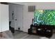 Bright living room featuring wood floors, a modern TV, and a cozy atmosphere perfect for relaxation at 4928 Lake Ridge Ln, Holiday, FL 34690
