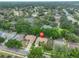 Aerial shot of a suburban community showcasing a property with mature trees and landscaping at 4942 Willow Ridge Ter, Valrico, FL 33596