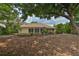 Expansive backyard featuring a patio and lush greenery, ideal for outdoor activities at 4942 Willow Ridge Ter, Valrico, FL 33596