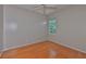 Empty bedroom with hardwood floors and a large window at 4942 Willow Ridge Ter, Valrico, FL 33596