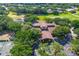 An aerial view of a stunning clubhouse surrounded by lush greenery and a well-manicured golf course at 4942 Willow Ridge Ter, Valrico, FL 33596