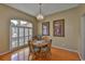 Cozy dining room with hardwood floors, a round table, and a charming chandelier at 4942 Willow Ridge Ter, Valrico, FL 33596