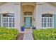 Inviting front entrance showcases a stylish blue door, sidelights, and decorative planters at 4942 Willow Ridge Ter, Valrico, FL 33596