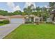 Well-maintained home features a spacious lawn, two-car garage, and vibrant curb appeal at 4942 Willow Ridge Ter, Valrico, FL 33596