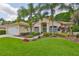 Charming single-story home boasts lush landscaping, mature palms, and a welcoming entrance at 4942 Willow Ridge Ter, Valrico, FL 33596