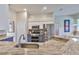 Modern kitchen with granite countertops, stainless steel appliances, and stylish blue cabinets at 4942 Willow Ridge Ter, Valrico, FL 33596