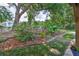 Beautifully landscaped yard featuring a variety of plants, flowers, and shrubs at 4942 Willow Ridge Ter, Valrico, FL 33596