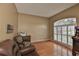 Comfortable living room with hardwood floors, large window with shutters, and cozy seating at 4942 Willow Ridge Ter, Valrico, FL 33596