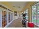 Bright sunroom with exercise equipment and views of the outdoors at 4942 Willow Ridge Ter, Valrico, FL 33596