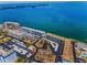 Aerial shot of waterfront condo community, featuring multiple buildings, carports, and water views at 5 Gateshead Dr # 308, Dunedin, FL 34698