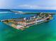 Stunning aerial view of waterfront condos surrounded by the tranquil turquoise waters at 5 Gateshead Dr # 308, Dunedin, FL 34698