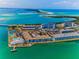 Aerial view of waterfront condo community with pools, tennis courts, and easy access to beaches at 5 Gateshead Dr # 308, Dunedin, FL 34698