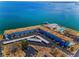 Beautiful aerial view of a waterfront condo community featuring a pool, clubhouse, and covered parking at 5 Gateshead Dr # 308, Dunedin, FL 34698