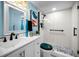 Well-lit bathroom featuring a modern vanity, glass shower, and decorative accessories at 5 Gateshead Dr # 308, Dunedin, FL 34698