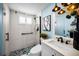 Modern bathroom featuring a glass-enclosed shower with black fixtures and a stylish mosaic tile floor at 5 Gateshead Dr # 308, Dunedin, FL 34698
