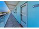 Exterior corridor of condo building with unit number 308, featuring a balcony and secure entry at 5 Gateshead Dr # 308, Dunedin, FL 34698