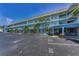 Condo building with balconies and palm trees, located at 5 Gateshead Drive with ample parking at 5 Gateshead Dr # 308, Dunedin, FL 34698