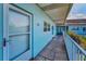 Condo exterior walkway leading to unit 308, showing the entrance and surrounding landscaping at 5 Gateshead Dr # 308, Dunedin, FL 34698