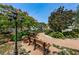Peaceful garden area with a bench, surrounded by lush greenery and colorful flowers at 5 Gateshead Dr # 308, Dunedin, FL 34698