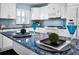 A kitchen island featuring a unique blue countertop, complete with accent decor and place settings at 5 Gateshead Dr # 308, Dunedin, FL 34698
