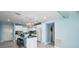 Bright, renovated kitchen with white cabinets, marble floors, and an island with bar seating at 5 Gateshead Dr # 308, Dunedin, FL 34698