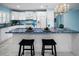 Bright kitchen with white appliances and cabinets, complemented by blue countertops and matching backsplash at 5 Gateshead Dr # 308, Dunedin, FL 34698