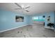Bright living room with a serene ocean view and beachy blue accent walls at 5 Gateshead Dr # 308, Dunedin, FL 34698