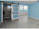 Bright main bedroom, featuring marble floors, en-suite bathroom access, and scenic ocean views at 5 Gateshead Dr # 308, Dunedin, FL 34698