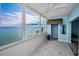 Inviting sunroom with ocean views, marble floors, and a cozy ambiance, perfect for relaxation at 5 Gateshead Dr # 308, Dunedin, FL 34698