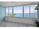 Breathtaking sunroom overlooking the ocean, featuring expansive windows and stylish marble floors at 5 Gateshead Dr # 308, Dunedin, FL 34698
