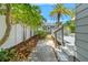 Backyard landscaping features a stone path leading to the storage building at 516 14Th Ne Ave, St Petersburg, FL 33701