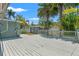 Large deck overlooks backyard with lush tropical landscaping and separate storage building at 516 14Th Ne Ave, St Petersburg, FL 33701