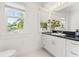 Bright bathroom with granite countertop, stylish mirror, and views to the outside at 516 14Th Ne Ave, St Petersburg, FL 33701