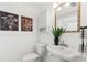 Charming half bathroom with pedestal sink, beadboard paneling, and decorative accents at 516 14Th Ne Ave, St Petersburg, FL 33701