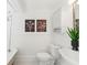 Half-bathroom featuring pedestal sink, toilet, tub and beadboard paneling at 516 14Th Ne Ave, St Petersburg, FL 33701