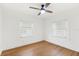 Bright bedroom features hardwood floors, ceiling fan, and ample natural light from two windows at 516 14Th Ne Ave, St Petersburg, FL 33701