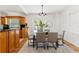 Dining room with modern chandelier, glass table, wood floors, and direct access to the outdoor patio at 516 14Th Ne Ave, St Petersburg, FL 33701